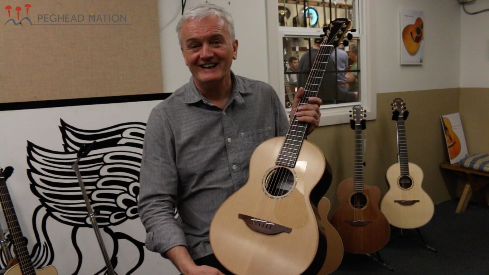 George Lowden holding the Wee Lowden at Gryphon Stringed Instruments in Palo Alto, CA
