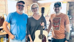 Mark Dalton, Kimberly Dalton and Brian Dickel with Huss & Dalton's 6,000th guitar